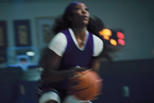 Basketball player Flau'jae Johnson holding a basketball getting ready to shoot