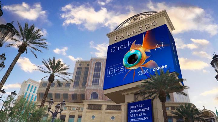 Outdoor billboard in Las Vegas featuring AI generated image of messed up orange fish with one large eyeball with the copy "Check AI Bias" featuring IBM and Adobe logos