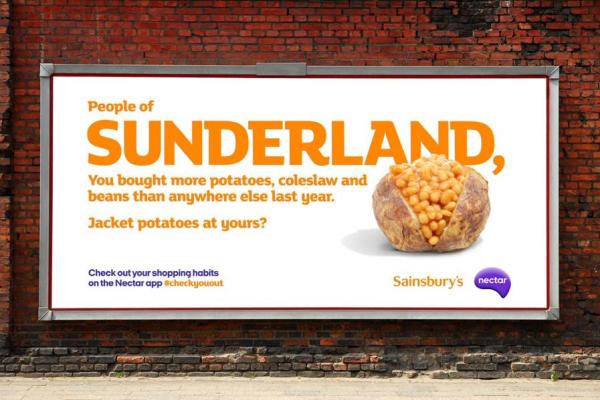 White and orange billboard describing how Sunderland bought the most coleslaw and potatoes in the UK