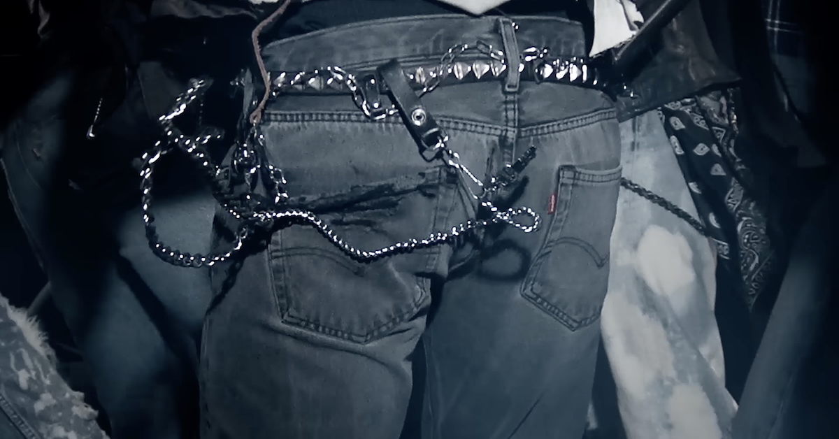Levi's jeans from the back with a chain hanging and swingin in motion from the person's belt