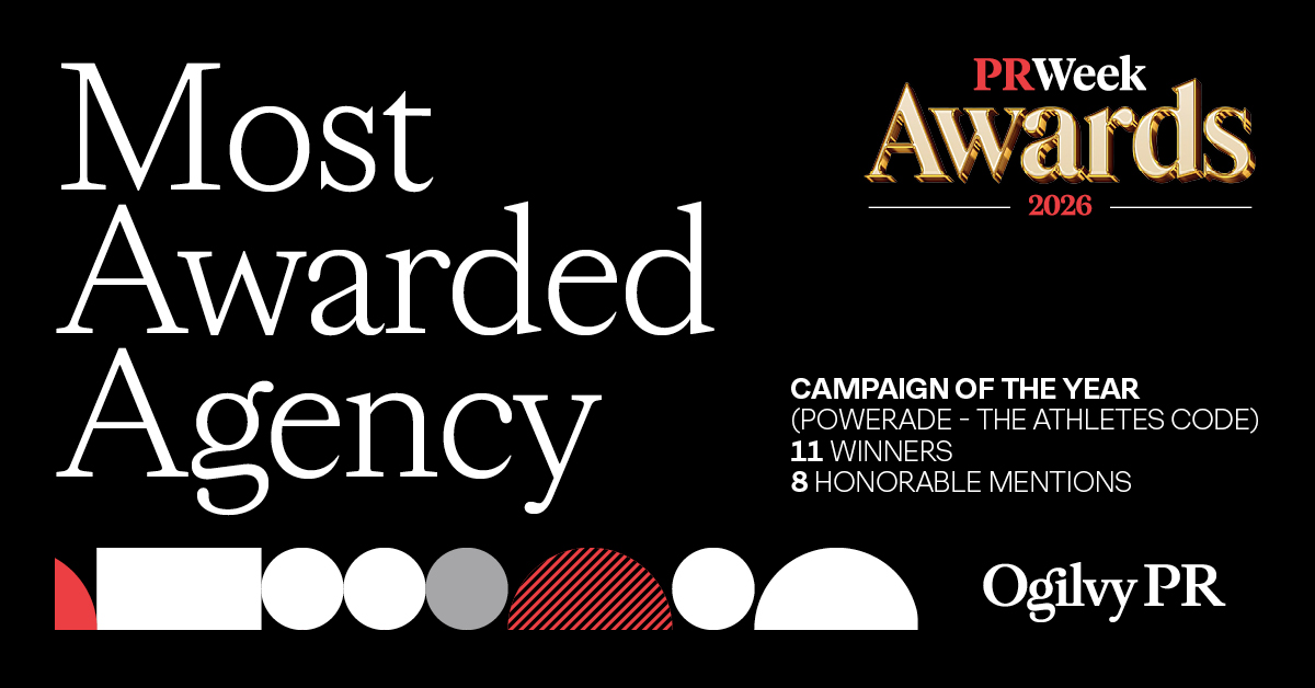 A black background with large white text on the left stating "Most Awarded Agency". On the top right, the "PRWeek Awards 2026" logo is displayed in gold and red. Below the logo, white text indicates "CAMPAIGN OF THE YEAR (POWERADE - THE ATHLETES CODE)", "11 WINNERS", and "8 HONORABLE MENTIONS". At the bottom right, the "Ogilvy PR" logo is shown in white, with a series of abstract red, white, and grey shapes in the bottom-middle.