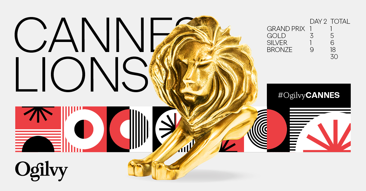 Ogilvy’s Cannes Lions Day 2 award tally graphic. A prominent golden Cannes Lion trophy is centered over a background of red, black, and white geometric patterns. The text reads 'CANNES LIONS' with the Ogilvy logo and the hashtag #OgilvyCANNES. A table shows the award count: Grand Prix (Day 2: 1, Total: 1), Gold (Day 2: 3, Total: 5), Silver (Day 2: 1, Total: 6), Bronze (Day 2: 9, Total: 18), for a cumulative total of 30 awards.