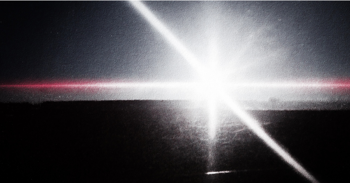 Image of white beam of light emanating from a crack.