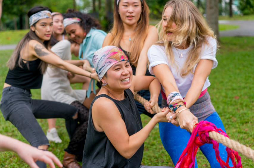 Group of employees playing tug-of-war at an off-site outing.