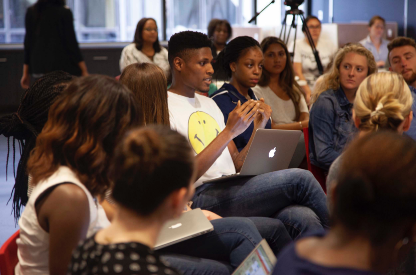 Employee making a comment during a Town Hall staff meeting.