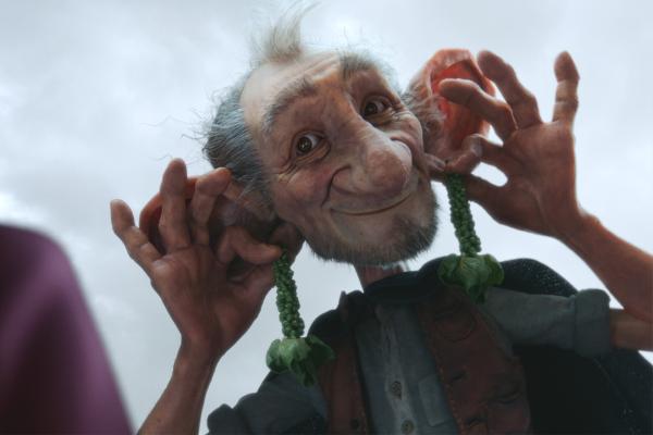 The BFG holding grape vines up to his ears like dangling earrings
