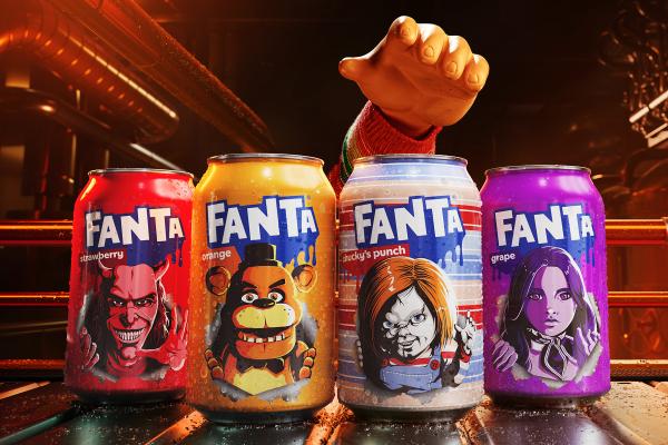 Four Fanta soda cans, each featuring a different horror-themed character, are lined up on a dark, wet, industrial surface. From left to right, the cans are: red "strawberry" with a devil-like face, orange "orange" with Freddy Fazbear, light blue "Chucky's punch" with Chucky, and purple "grape" with a female character resembling Wednesday Addams. A large, cartoonish hand in a striped sleeve reaches down from the top right, as if to grab a can. The background is dark and blurry with industrial pipes and light