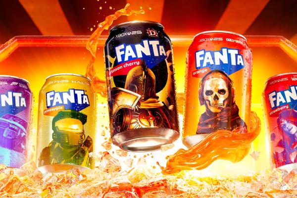 Assorted Fanta cans in different flavors, including crimson cherry, orange, pineapple, and strawberry, arranged against a bright orange background with splashing soda and ice.
