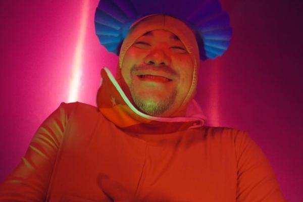 Person wearing futuristic/sci-fi looking red jacket with blue headwear