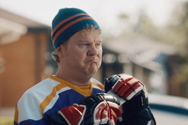 Hockey player wearing a winter hat with a frown on their face