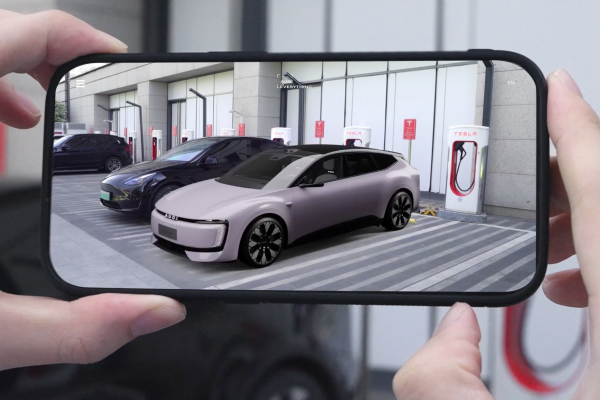 Person holding mobile phone up with app generating AI image of Audi E5 