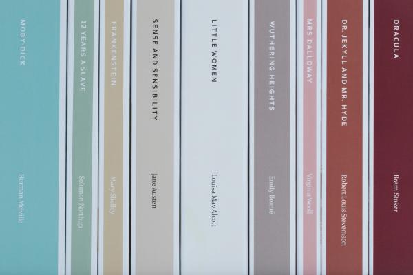 Vertical row of spines of classic books, each a different color/shade of Dulux Heritage paint 