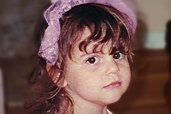 Old photo of young girl wearing a pink headband