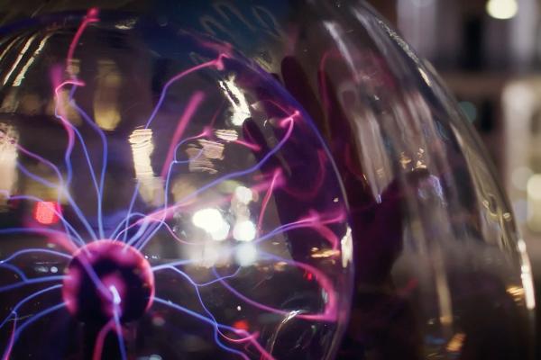 Close up of purple electric currents inside of a glass sphere
