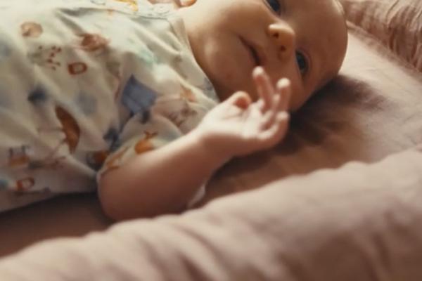 Baby laying on an infant mattress