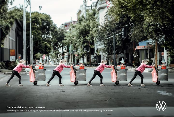 X4 - Volkswagen Four time Repeating image of a woman pushing a shopping cart crossing a street in a crosswalk