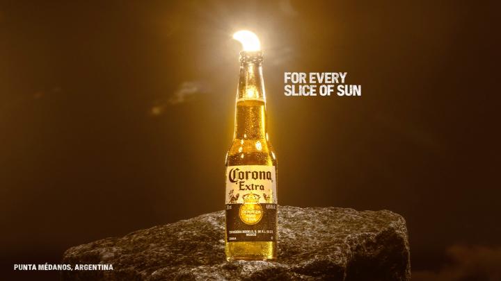 For Every Sunset — Corona Eclipse sun appearing as a lime wedge in a Corona bottle, with copy "For Every Slice of Sun"