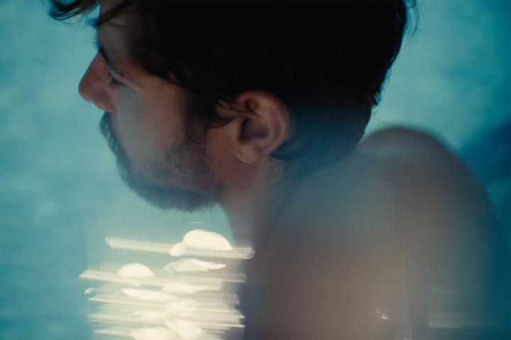 The Athletes Code — Powerade CLose up profile of person in the foreground and pool water in the background