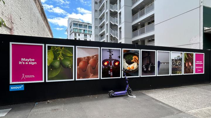 A row of outsoor advertisements. The first says "Maybe it's a Sign". Then in succession left to right: A pair of limes; two eggs in a carton; a railroad stop light; two sunny side up eggs; a pair of dumbbells; two droplets of water hanging off a thin rod; a bicycle; two potatoes on the ground. Then a final poster says "Book your Mammogram"