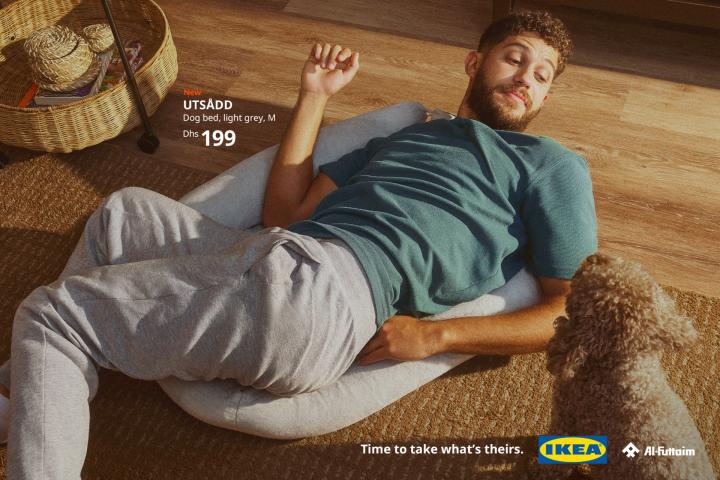 Time to Take What's Theirs — Al-Futtaim IKEA A man lying on his back on a pet bed, his dog looking at him