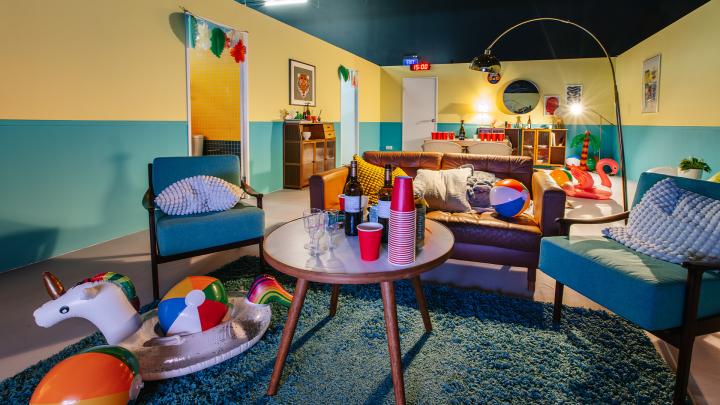 Uninfluenced — Singapore Central Nacrotics Bureau Image of a colorful room. On the table are a stack of red cups and bottles of wine and liquor. Ther are inflatable pool floats on the floor and on the couches as well as beach balls