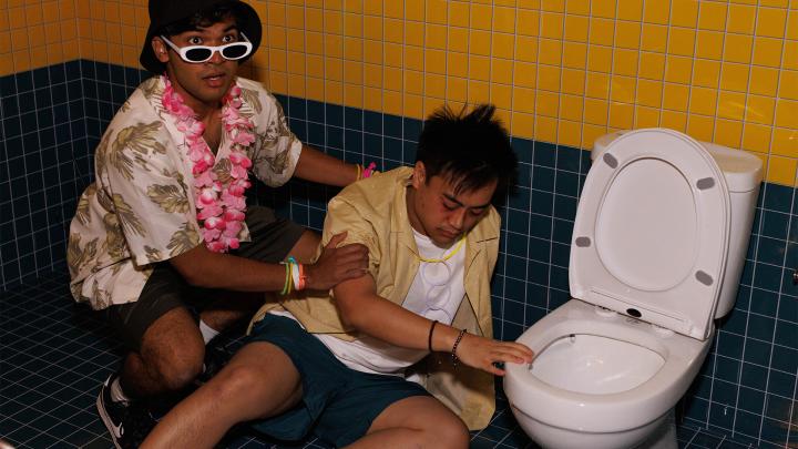 Uninfluenced — Singapore Central Nacrotics Bureau Two young singaporeans on the floor of a bathroom. One appears to be sick, next to the toilet, while the other looks concerned and is helping