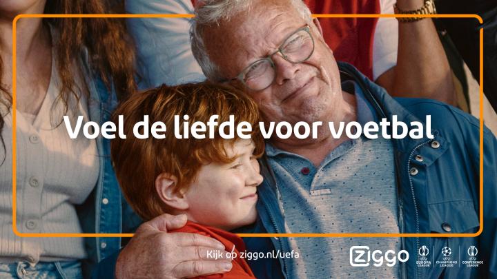Experience the Love of Football Together — Ziggo Sport Older man and young child embracing in crowd at football match with text overlay "Voel de liefde voor voetbal"