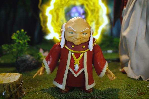 Animated image of Dungeons and Dragons wizard character wearing a red and gold robe in front of a blue and yellow portal