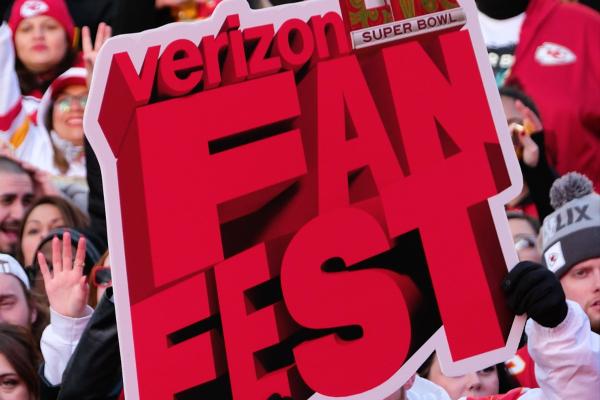 Image  with "Verizon Fan Fest" in big red lettering, with various football fans surrounding the letters
