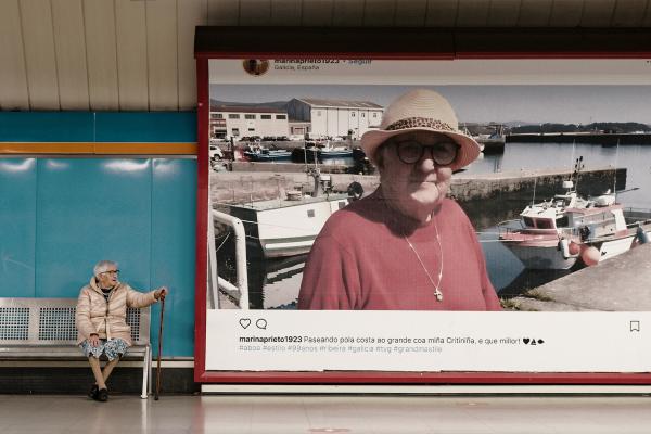 An image of 99 year old Marina Prieto posting happily with groups of people for photos and selfies.. In the center of the collage is an instagram post from "marinaprieto1932"  "Madrid's subway"