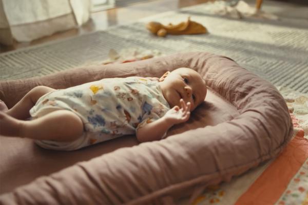 Baby laying on an infant mattress