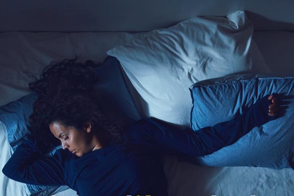 Woman lying on an unmade bed